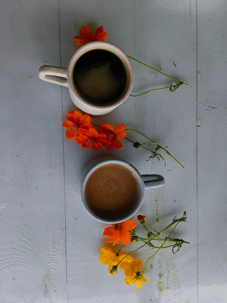 Two coffees styled with flowers at the Pawna lake cafe