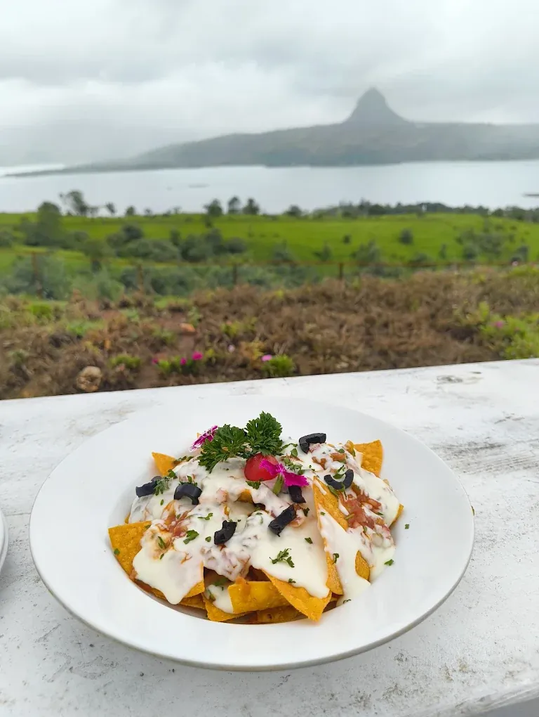 Plated dessert with a Pawna Lake view at the restaurant