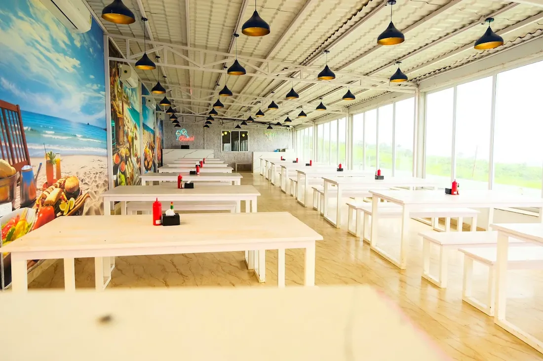 Bright dining hall with white tables at The Oven Lakeside